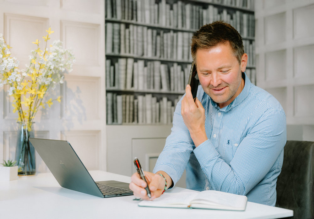 Ian Storey, Founder of Storeys Of Cheshire, on the phone in the office