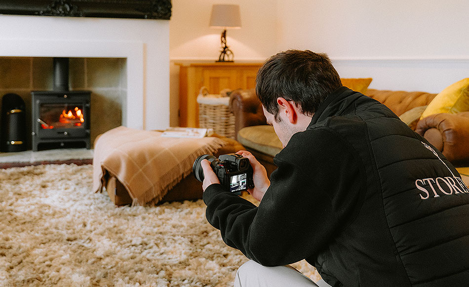 Professional photographer at Storeys Of Cheshire Estate Agents shooting a living room